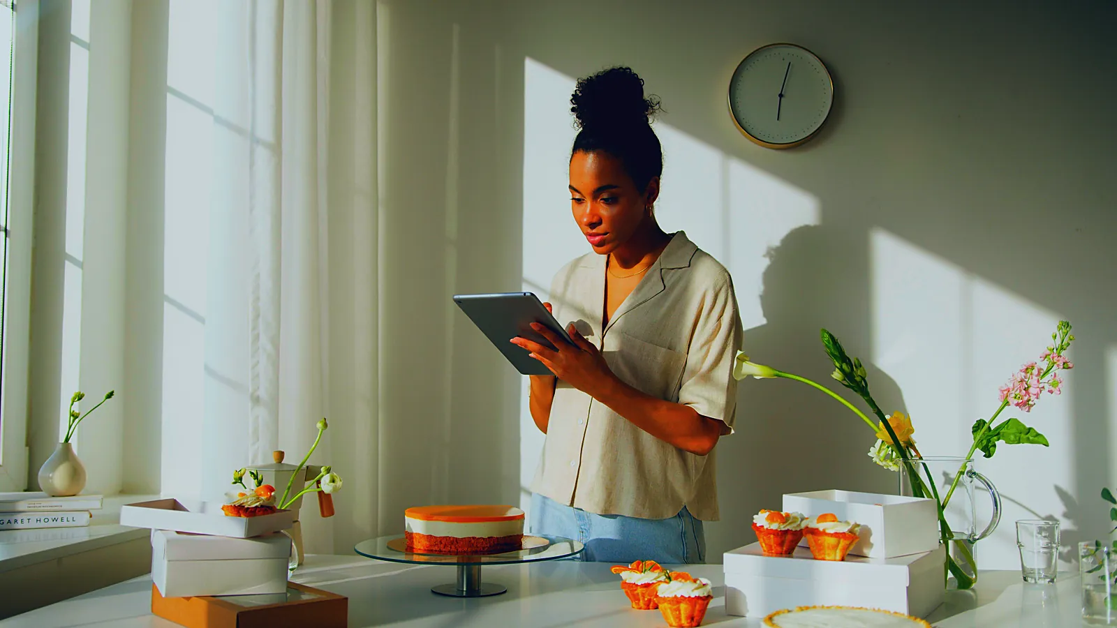 Bakery owner checking her numbers on a tablet in the morning