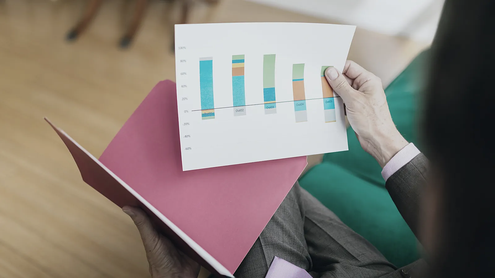 Owner holding a printed financial report with a bar chart