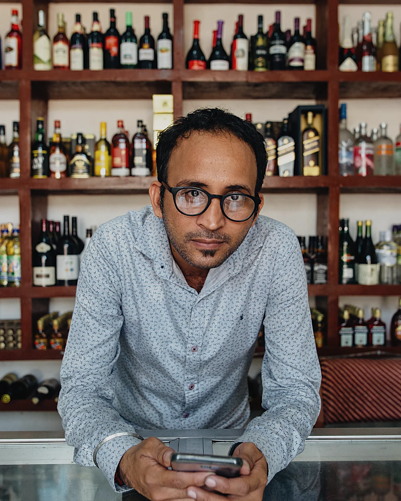 Liquor store owner behind the counter
